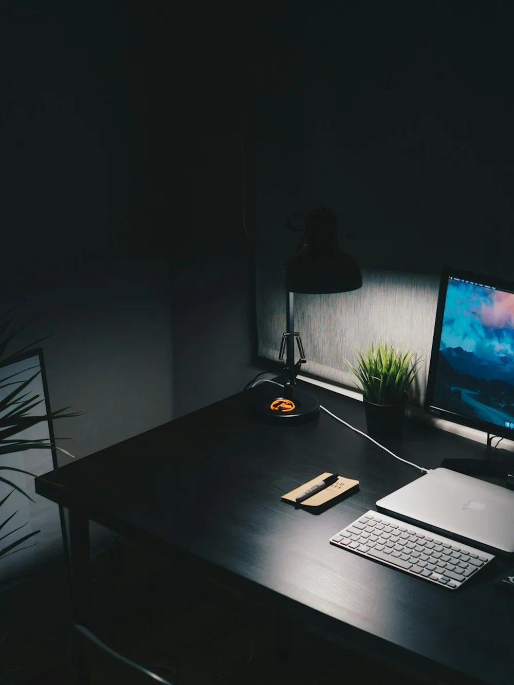 A desk workstation in a darkened room